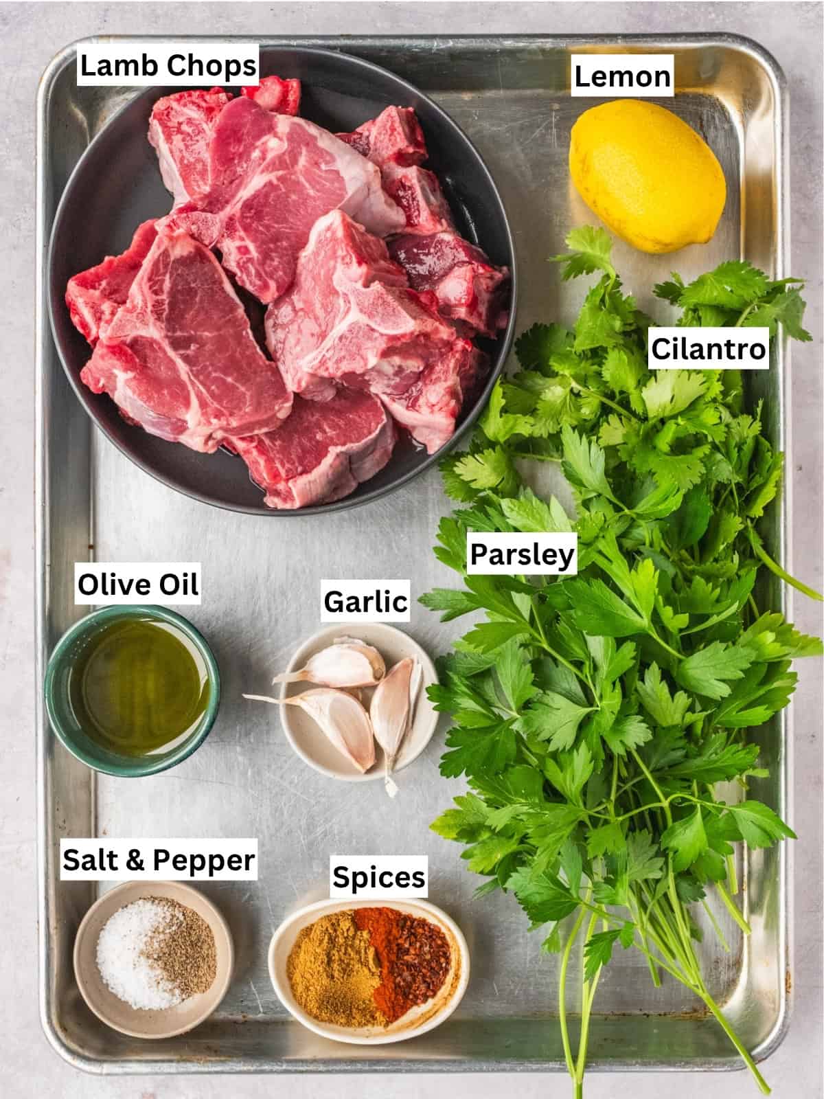 North African grilled lamb loin chops recipe ingredients with individual labels on a metal tray.