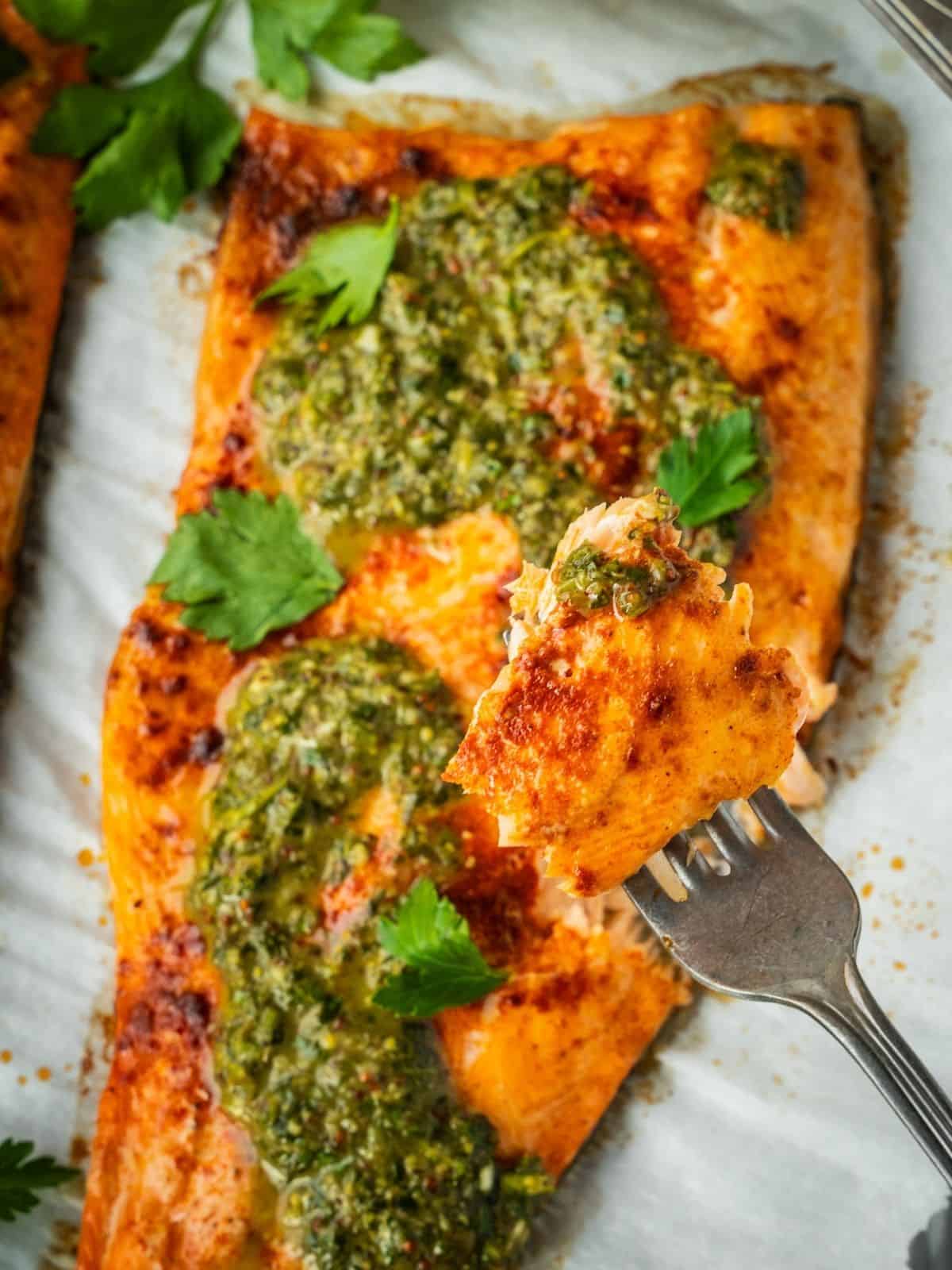 A forkful of Baked Trout with Pomegranate Molasses Herb Sauce.
