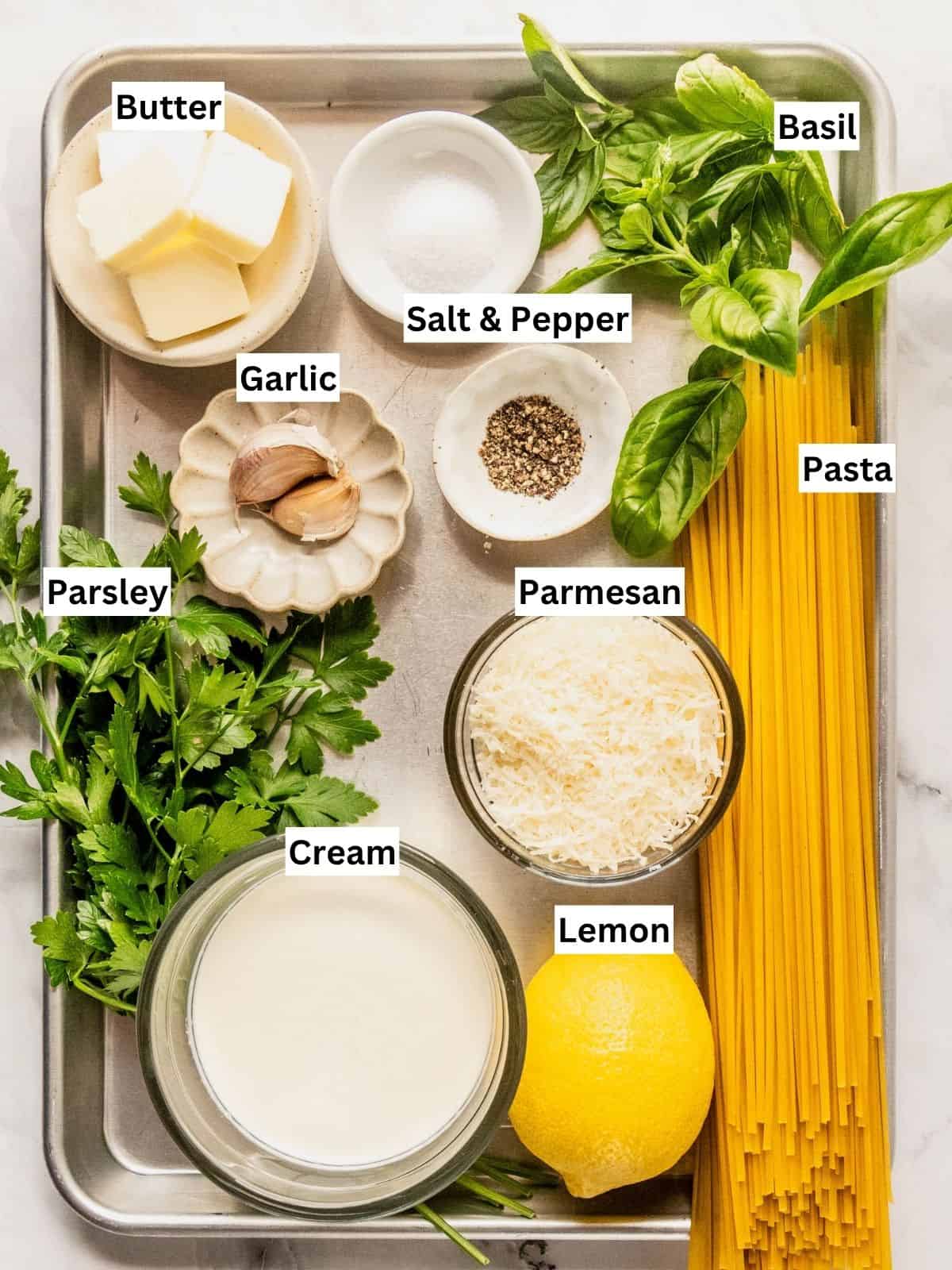 Creamy pasta al limone recipe ingredients with individual labels on a metal tray.