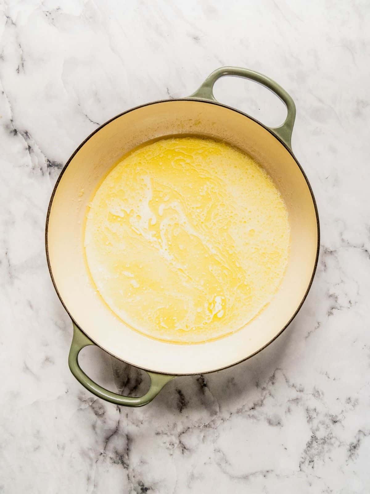 Saucepan with butter, garlic and cream.