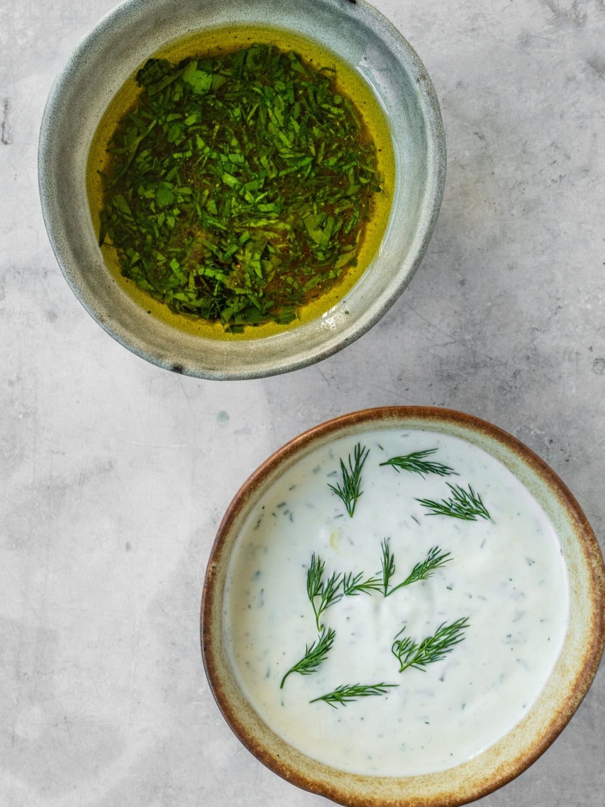 Herb and yogurt sauces in bowls.
