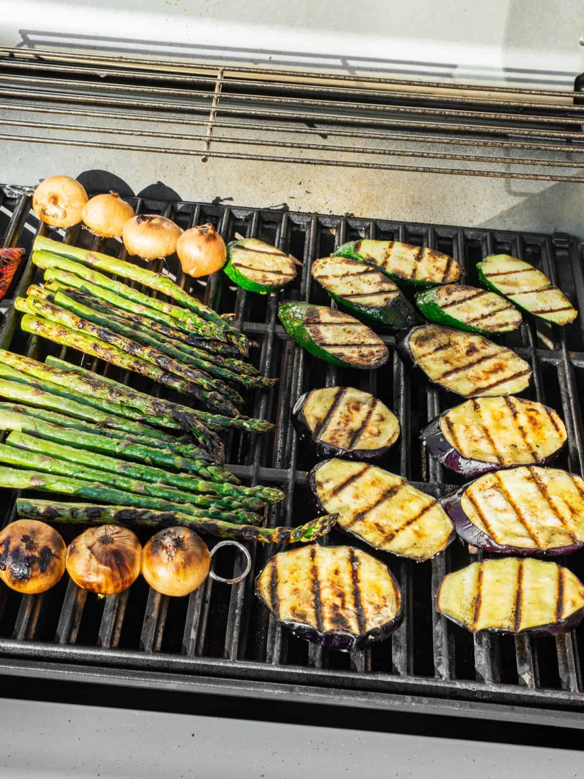 Vegetables grilling on an outdoor gas grill.