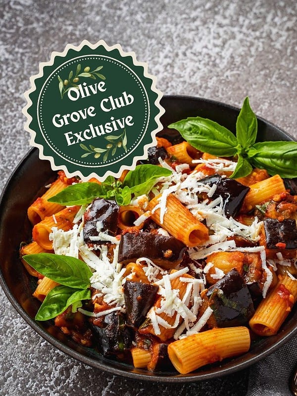 Pasta alla Norma with eggplant, basil and ricotta in a bowl.