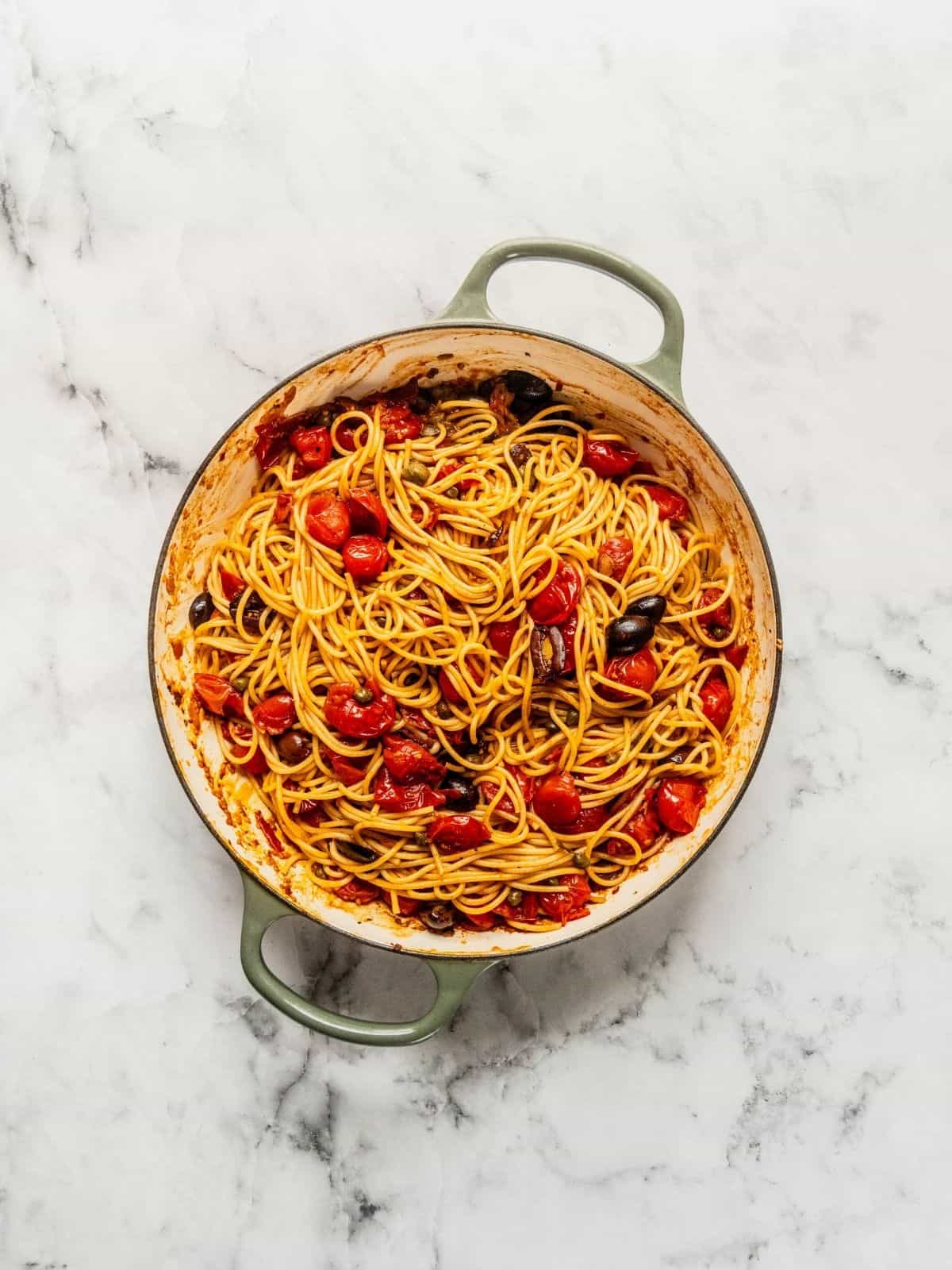 Finished pasta puttanesca tossed and ready to serve.