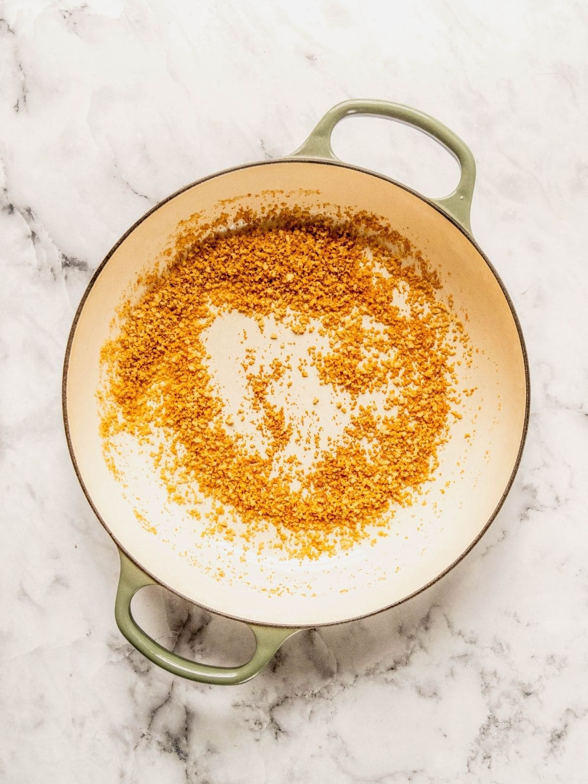 Breadcrumbs toasting in a saucepan.