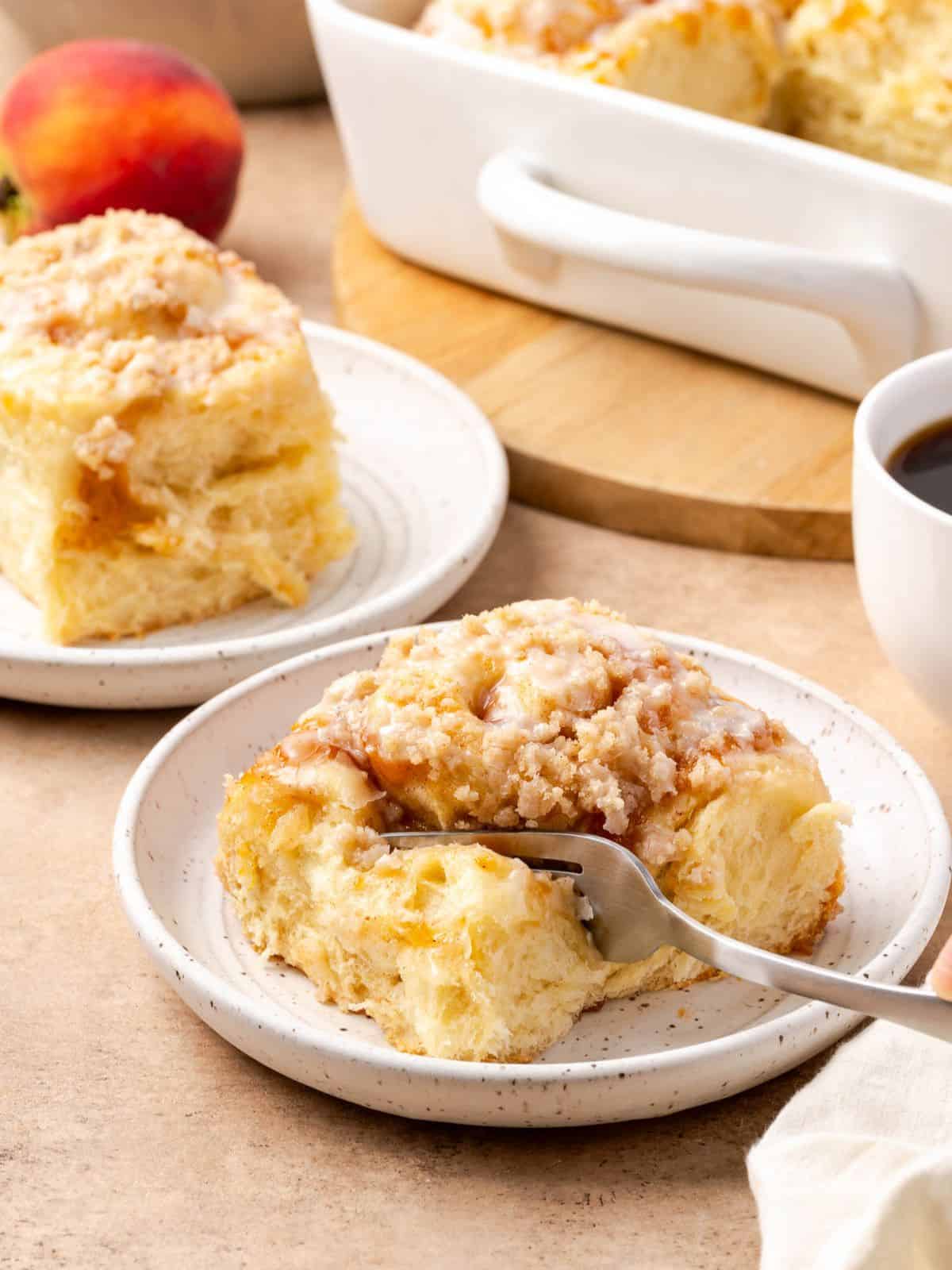 Peach cobbler cinnamon roll on a plate.