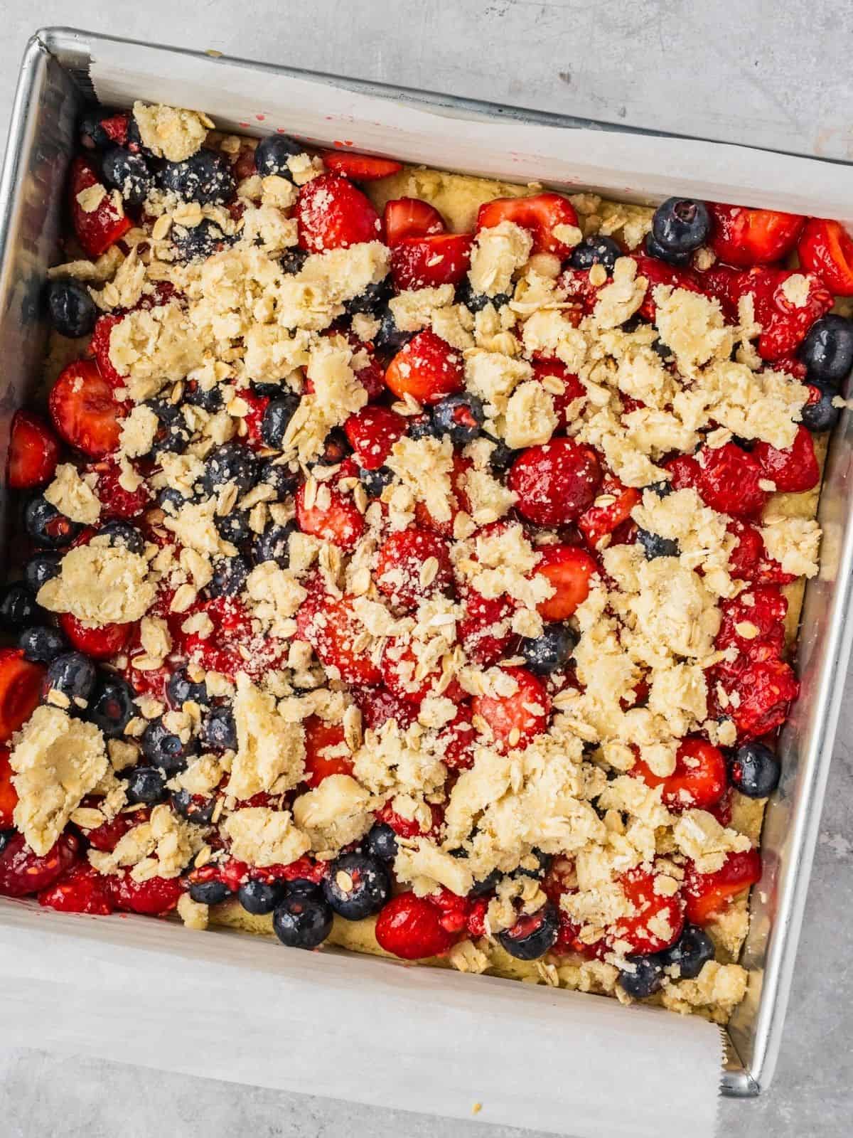 The assembled bake with berry mixture and topping layered over the par-baked crust.