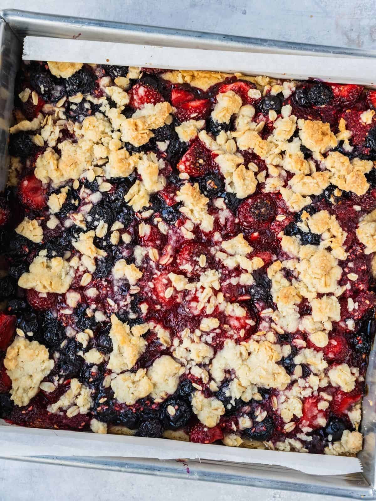 The finished bake, showing golden topping and bubbling berry filling.
