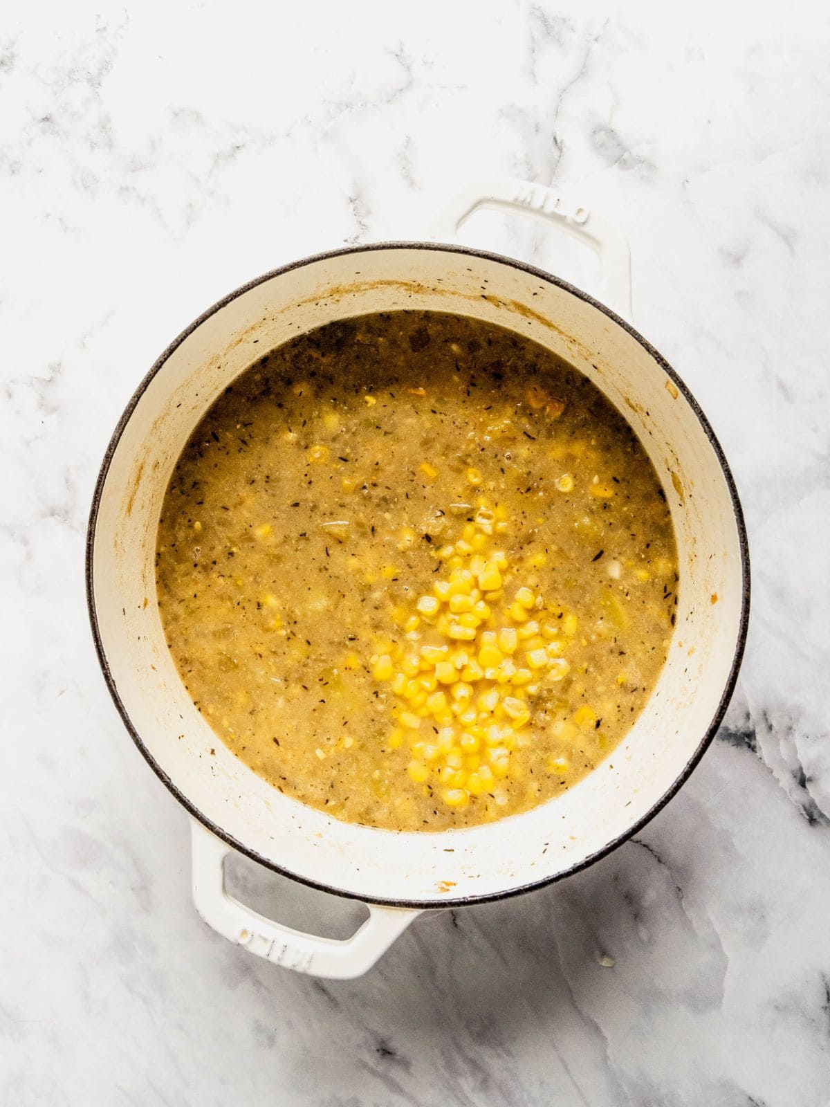 Soup pot with partially blended chowder base.