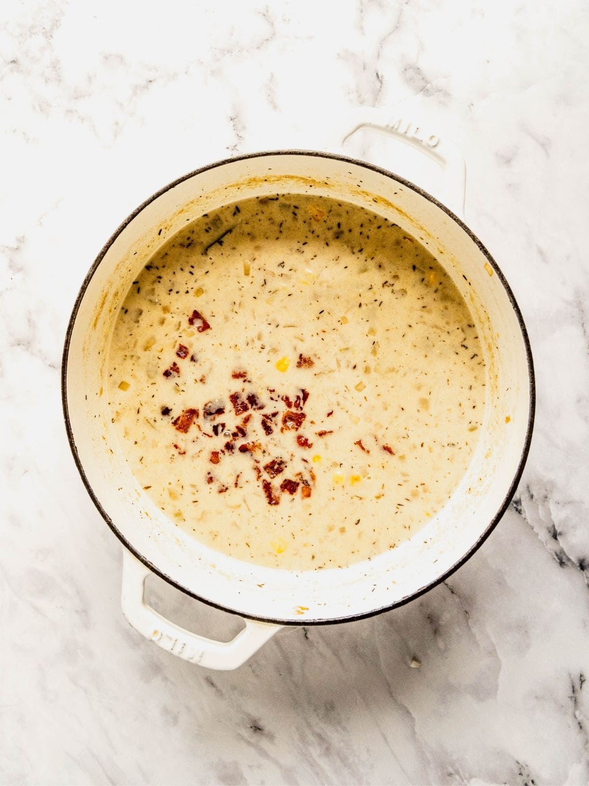 Cream, bacon and more corn added to the blended soup base.
