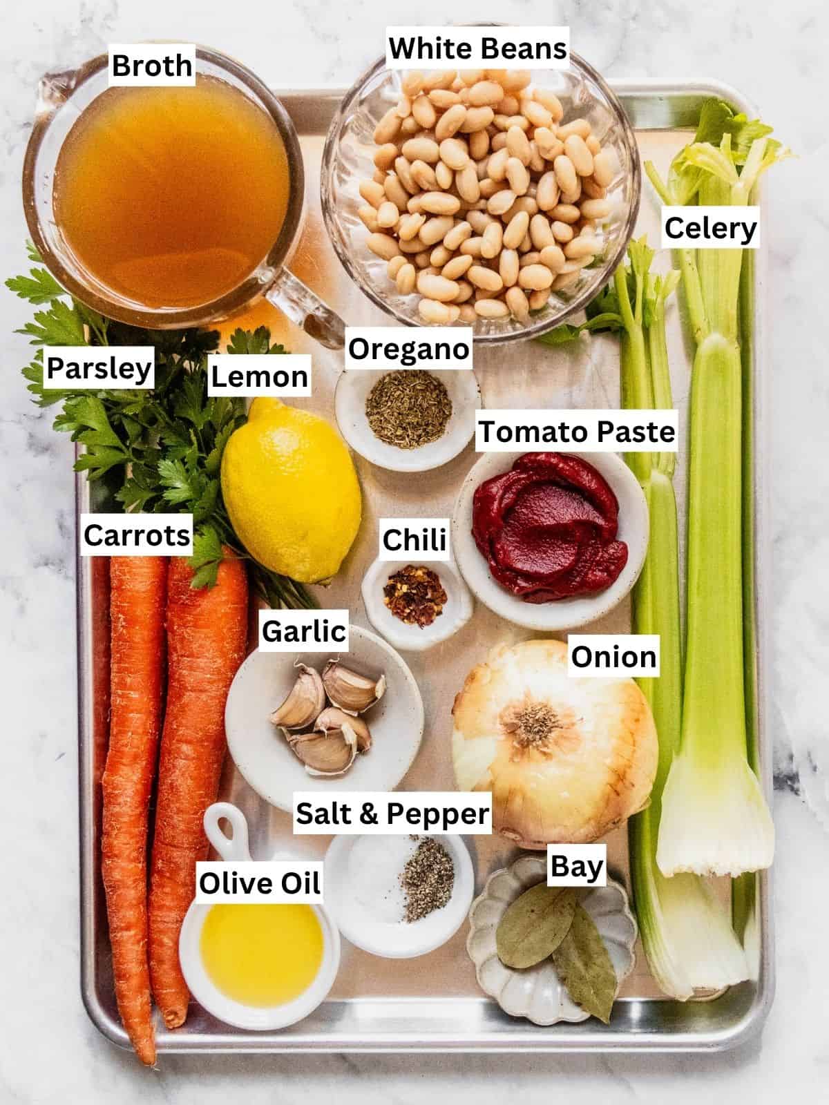 Fasolada Greek white Bean Soup recipe ingredients with individual labels on a metal tray.