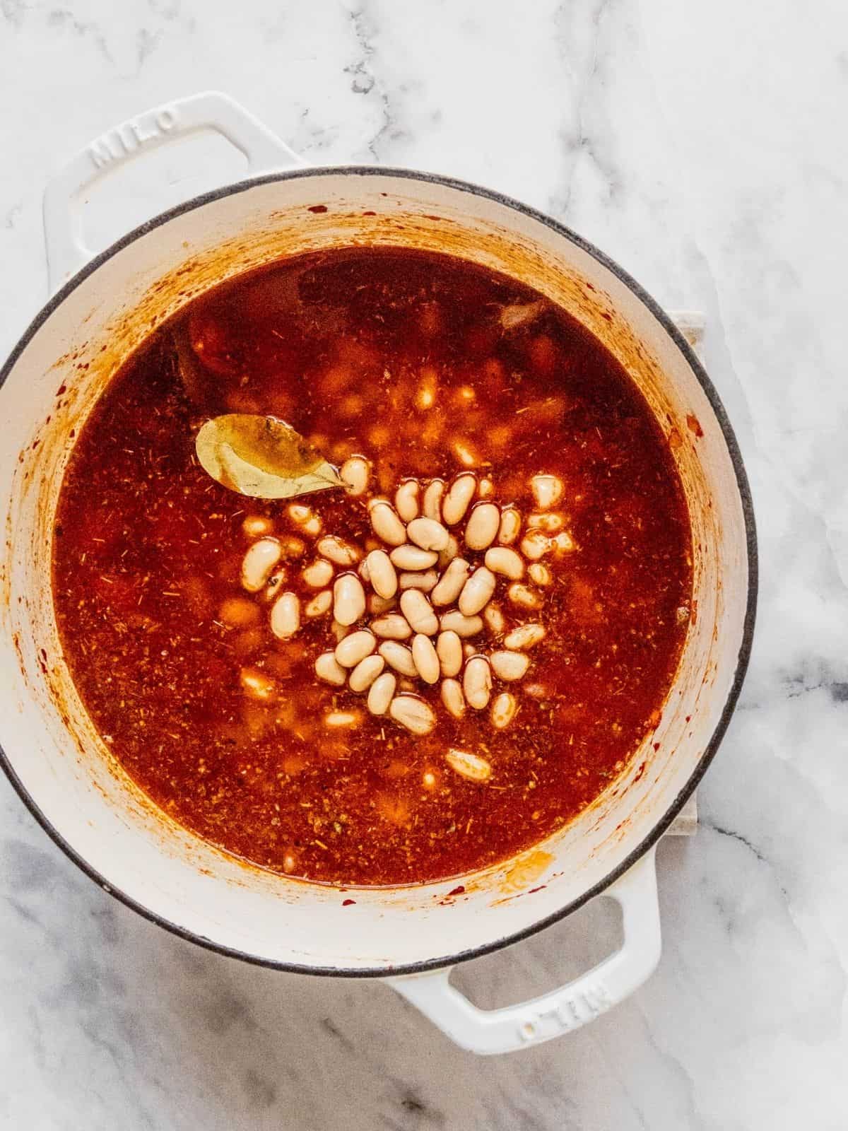 Adding the beans to soup base.