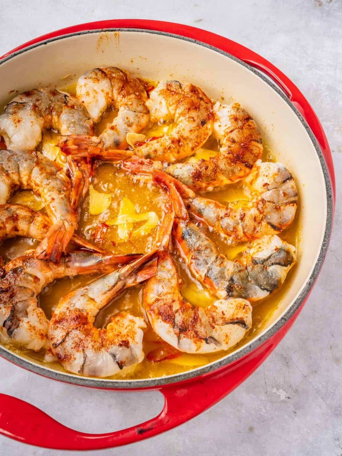 Shrimp cooking in the skillet with olive oil, garlic and chili.
