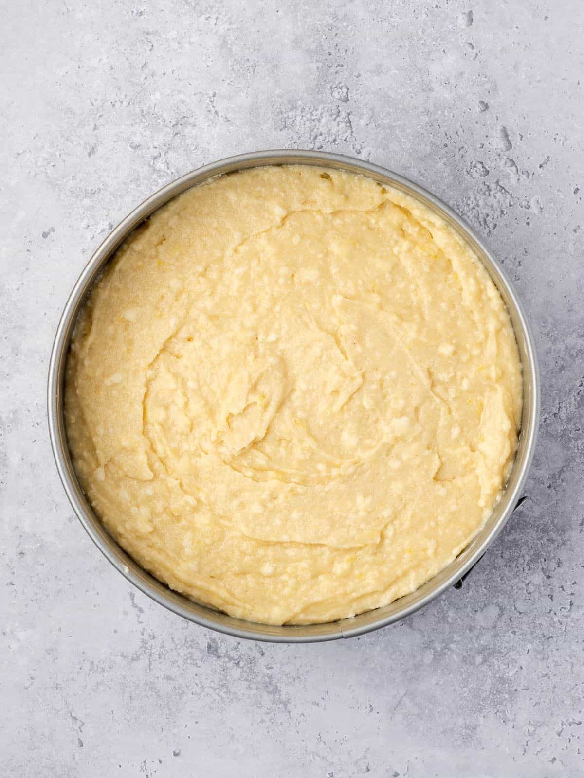 Cake batter in a cake pan.