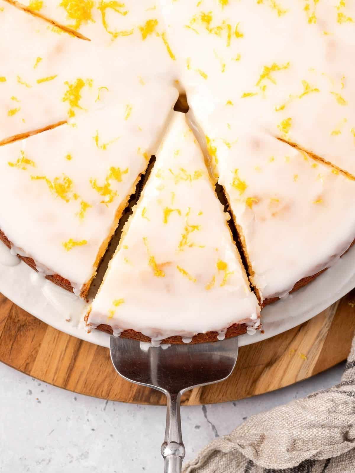 Slices of lemon ricotta cake on a plate, garnished with icing and lemon zest.