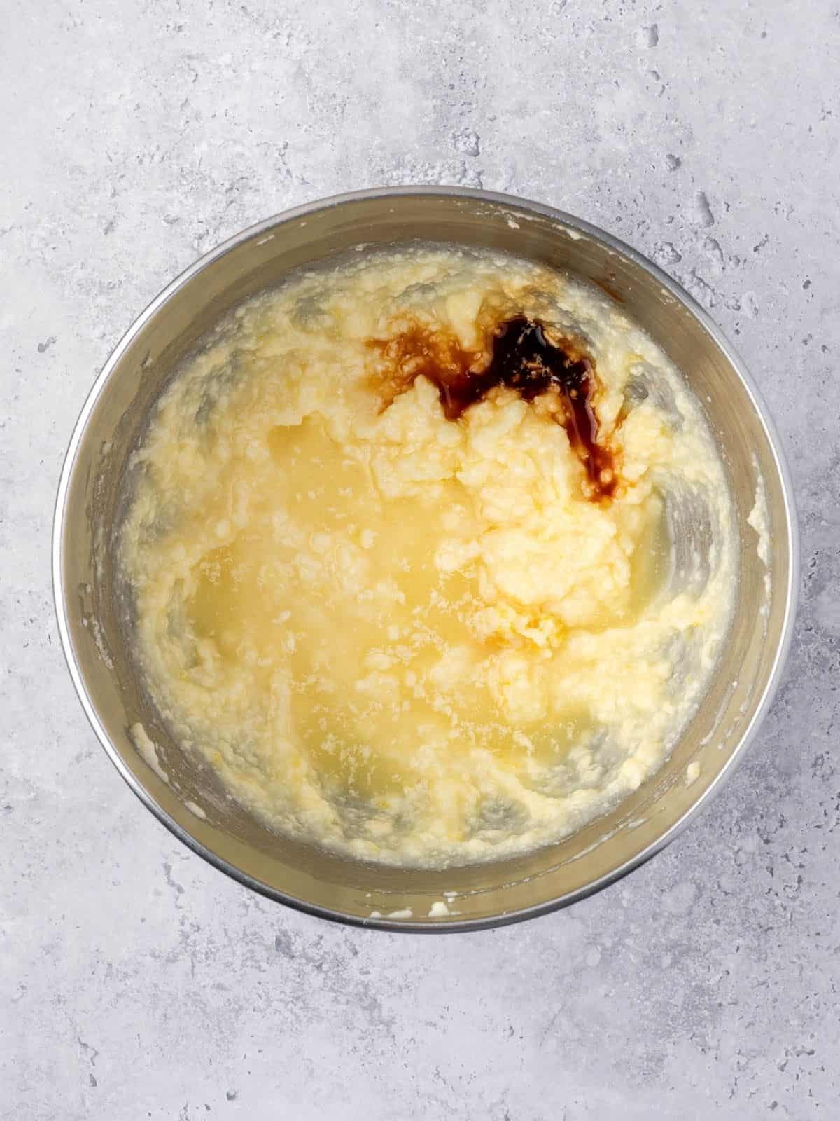 Recipe step showing the addition of vanilla to the cake batter.