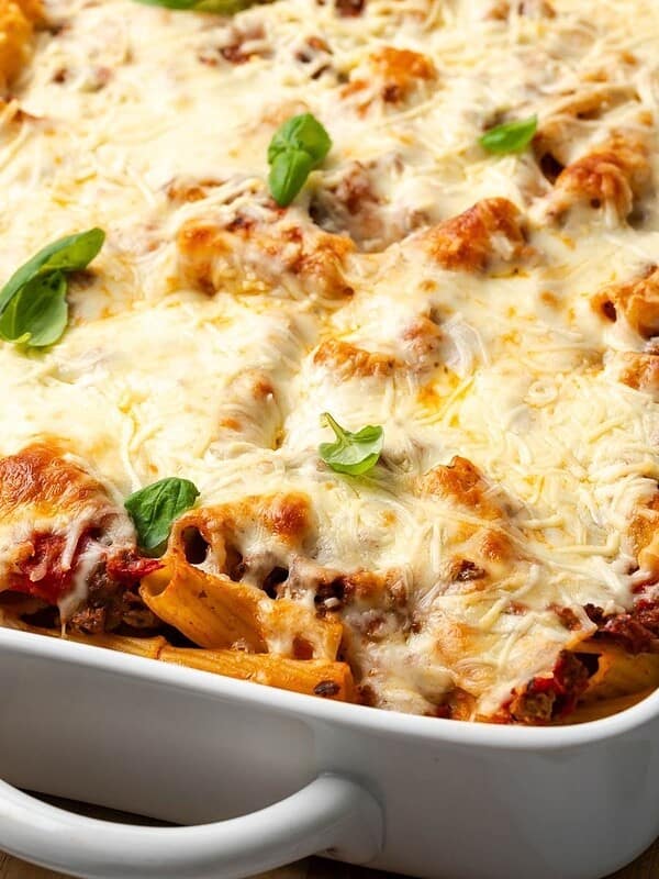 Pasta al Forno with Beef in a baking dish garnished with fresh basil.