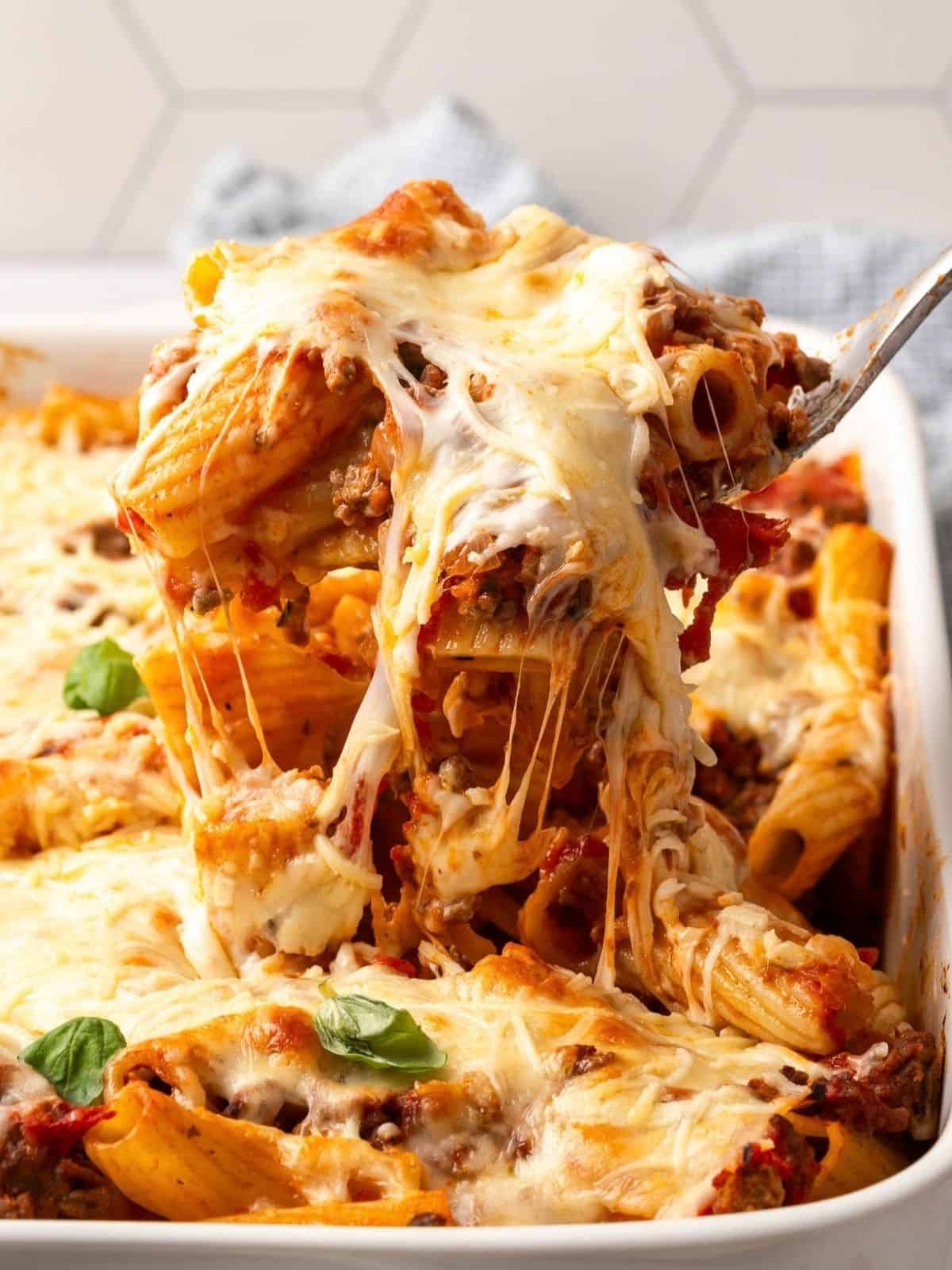 Pasta al Forno with Beef in a baking dish garnished with fresh basil.
