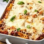 Pasta al Forno with Beef in a baking dish garnished with fresh basil.