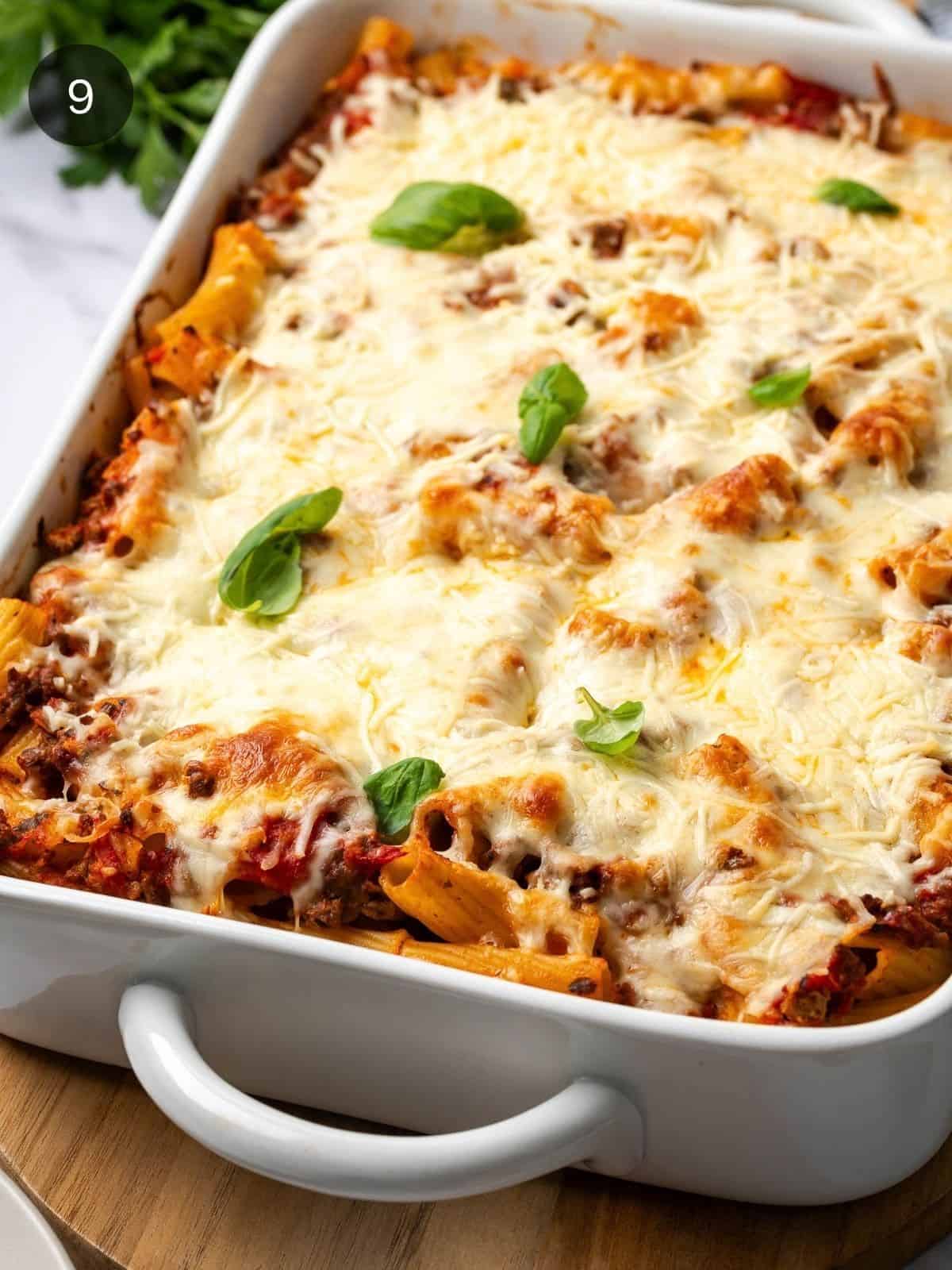 Pasta al Forno with Beef in a baking dish garnished with fresh basil.
