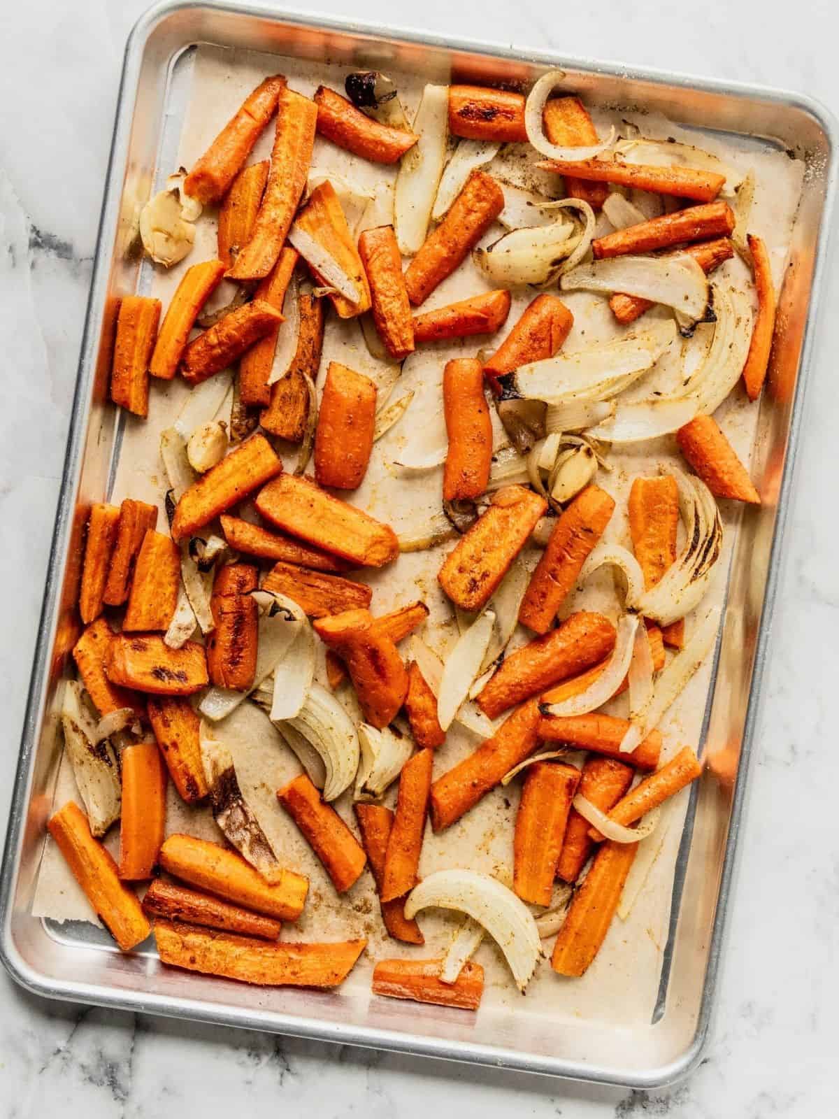 Baking sheet with carrots and onions.