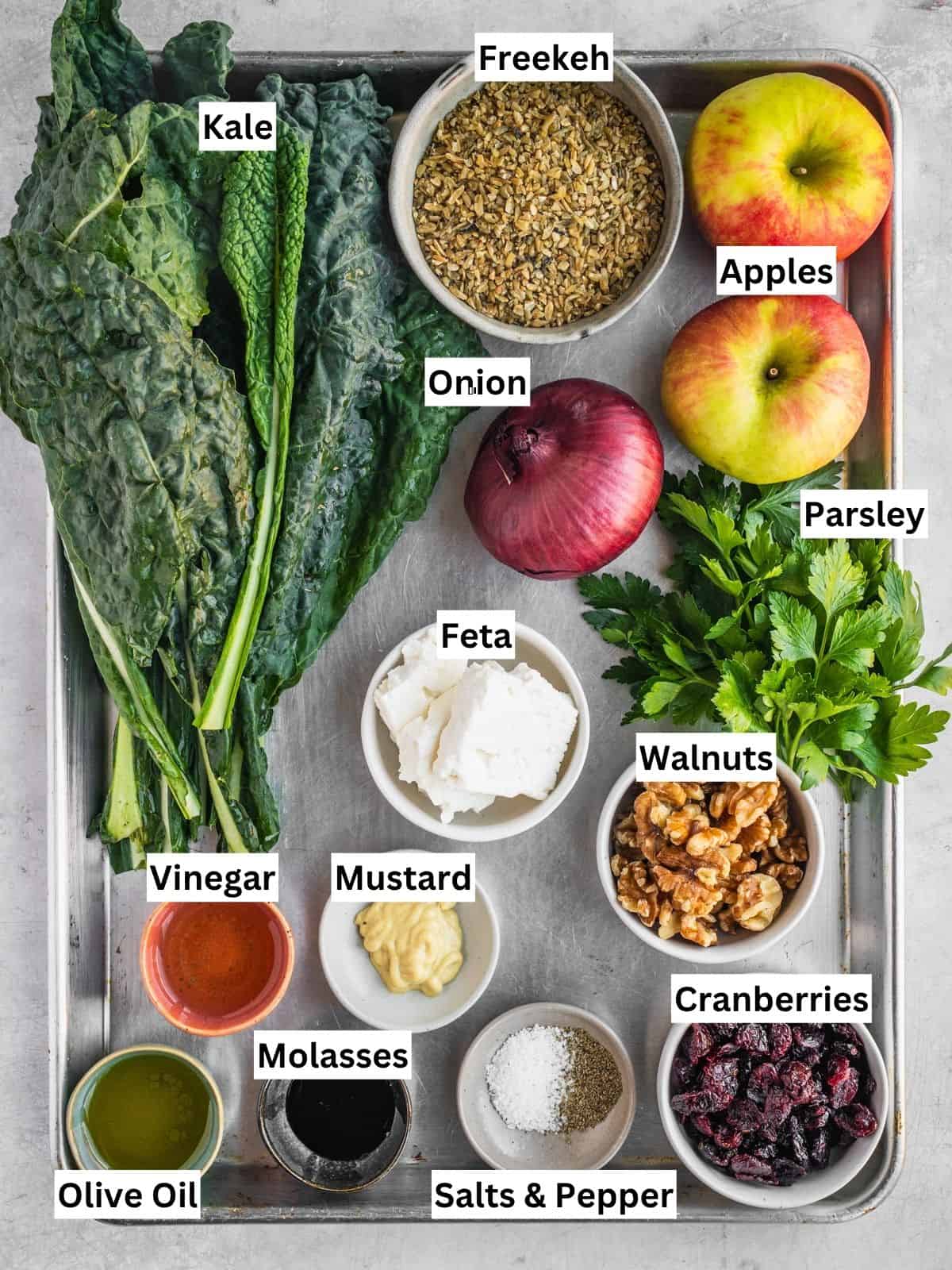 Apple Freekeh Kale Salad recipe ingredients with individual labels on a metal tray.