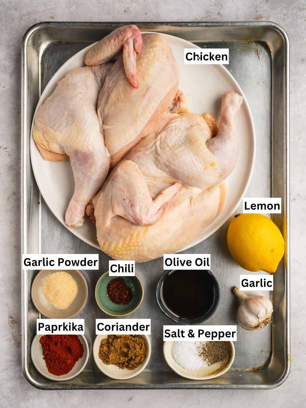 Portuguese Shop Style grilled Piri Piri Chicken recipe ingredients with individual labels on a metal tray.