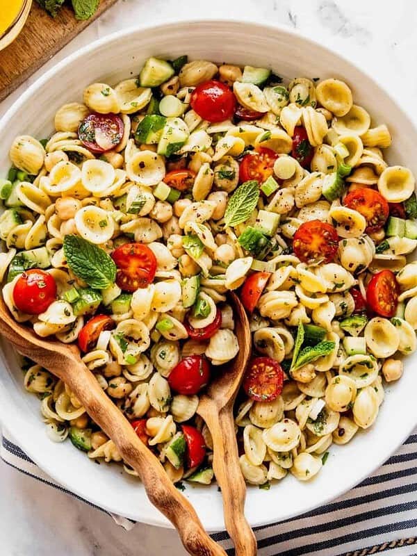 Bowl of vegan Mediterranean pasta salad with chickpeas.